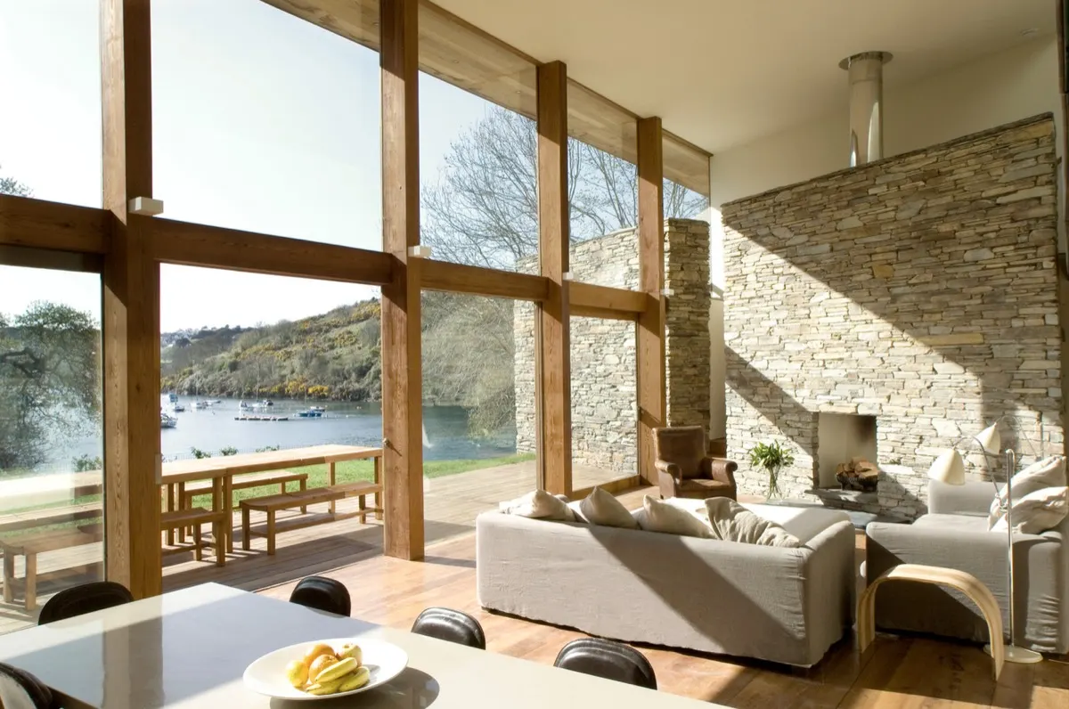 Living room with wall of windows overlooking the water